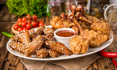 fried chicken wings in batter with ketchup and sauce