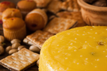 Food composition of gourmet cheese, close up. Quality sort of Caciotta with pastry products and nuts around, sunny mood concept. Dairy local industry
