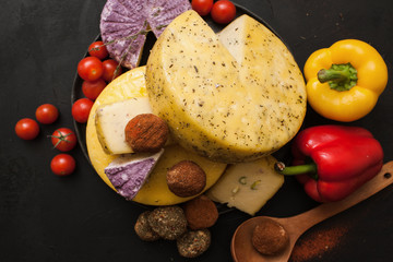 Cheese assortment. Dairy milk products, top view. Healthy food with variety of vegetables around