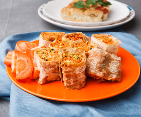Rolls with vegetables on gray background.