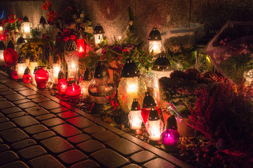 Graveyard candles on Polish cemetery during All Saints Day at night.