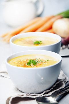 Vegetable cream soup in bowl over grey concrete background