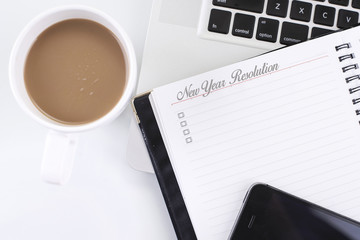New Year Resolution  word and computer, smart phone, coffee cup. Top view with copy space