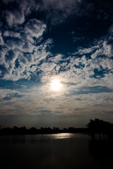 The spread clouds in dark blue with sun shining