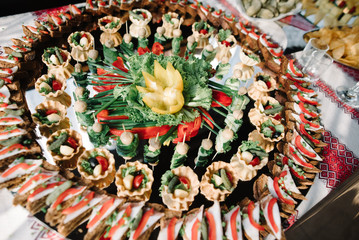 decorated catering banquet table with snacks and different food