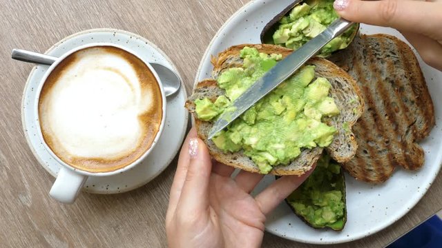 Top View Of Healthy Breakfast With Avocado Toast And Coffee In Cafe. Closeup. 4K. 