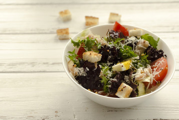 Salad, caesar  on white wooden background and copy space