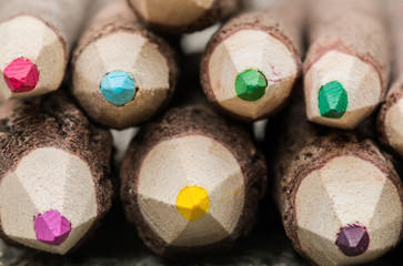 Extreme close-up Stack of wooden tree branch colorful pencils.