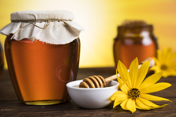 Jar full of fresh honey and honeycombs
