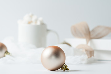 rose gold christmas decorations and ribbion on a white background