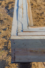 angle knocked together from boards, timber framing of a house under construction