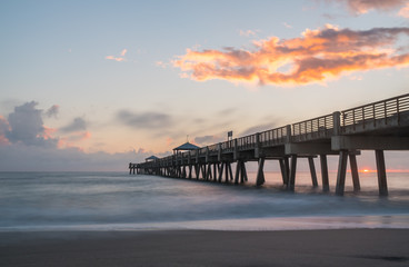Fototapeta na wymiar Sunrise over pier with beach