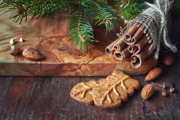 Christmas time, closeup on almond cookies with cinnamon sticks,
