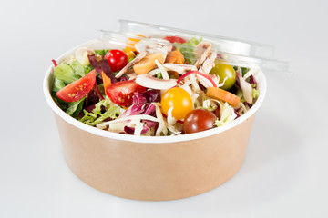 Fresh organic mixed green salad with pumpkin in carton kraft box