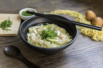 Shrimp wonton with braised pork in soup on wooden table - Asian food style, Select focus image