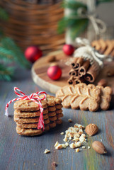 Sloseup on almond cookies with cinnamon sticks, clovers, almonds and Christmas tree twigs