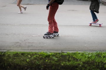 Roller skate legs close up in skatepark. foot on a roller Board and a runner on the background
