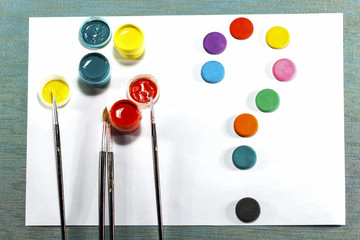 gouache, tassels, watercolor paint, white sheet of paper. all for drawing.