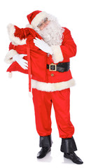 Santa Claus carrying big bag. Isolated on white background. Full length portrait