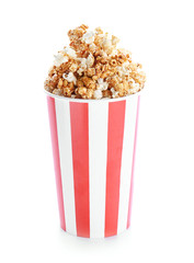 Cup with tasty caramel popcorn on white background