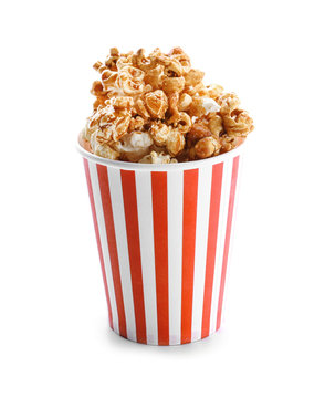 Cup with tasty caramel popcorn on white background