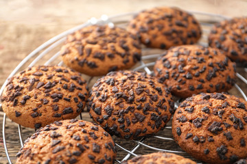 Cooling rack with delicious oatmeal cookies on table, closeup