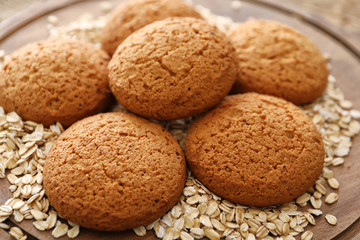 Delicious oatmeal cookies on wooden board, closeup