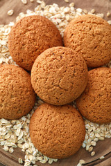 Delicious oatmeal cookies on wooden board, closeup