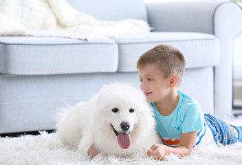 Cute little boy with dog at home