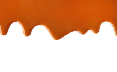 Flowing caramel sauce, isolated on white