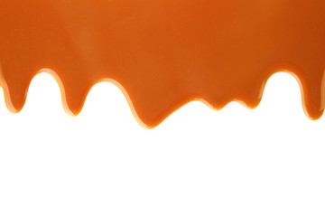Flowing caramel sauce, isolated on white