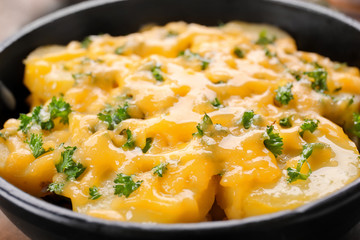 Delicious potato casserole in frying pan, closeup