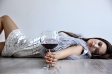 Young woman drinking alcohol at home