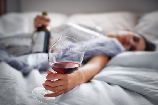 Young Woman Drinking Alcohol At Home