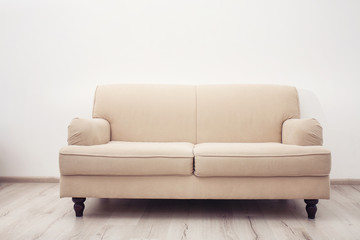 Comfortable sofa against white wall indoors