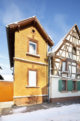 Fototapeta na wymiar Narrow House In Winter Village, Germany