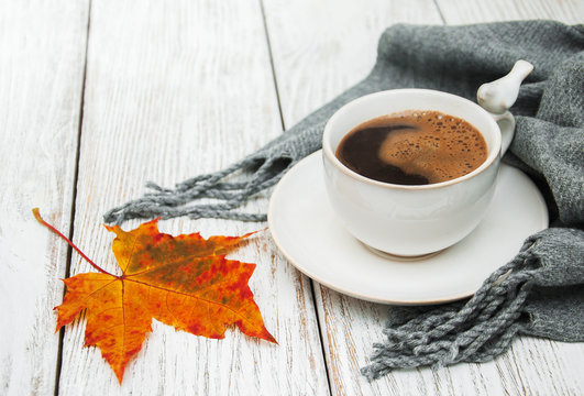 Cup of coffee and autumn leaves