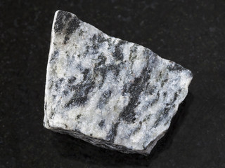 raw migmatite stone on dark background
