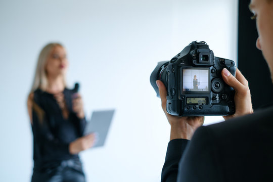 Backstage Video Filming Equipment Concept. TV Presenter Standing Behind The Camera