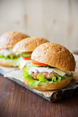 Closeup of home made burgers on wooden background