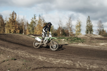 Motocross driver on race track