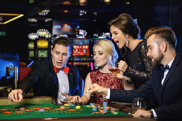 Young and rich people playing roulette in the casino