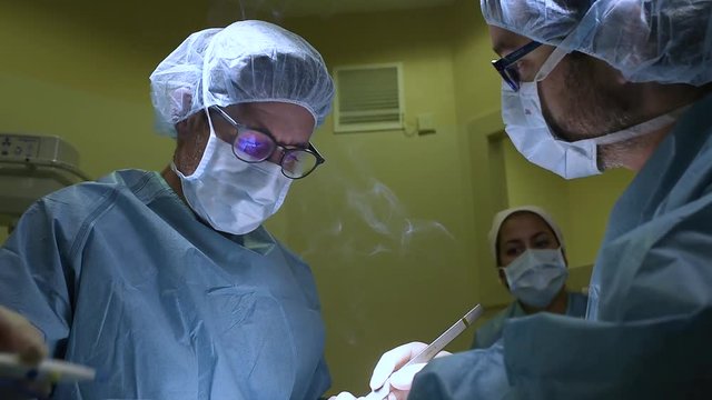 Surgeons doing a foot surgery. 