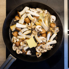 Pilze braten in Butter in einer Bratpfanne