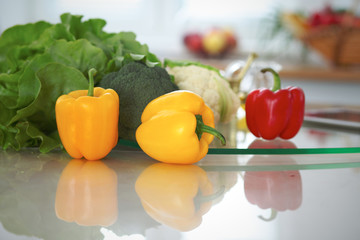 Kitchen interiors. Many vegetables and other meal at glass table are ready for been cooked soon