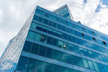 Fototapeta na wymiar Glass office building on sky background