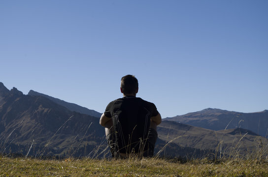 Boy thinking on the top of a mountain