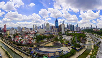 Fototapeta na wymiar Panorama view of Kuala Lumpur city skyline with dramatic cloud formation and blue sky.