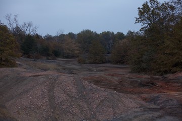 Trails run through an old colorful coal mine on a cloudy fall day