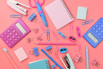 Fototapeta na wymiar Stationary concept, Flat Lay top view of school supplies scissors, pencils, paper clips,calculator,sticky note,stapler and notepad in pastel tone on pink background with copy space, flat lay design